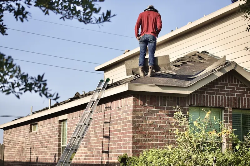 Professional roofer working on a residential roof in Fox Hills